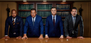 Partners Stampone, O'Brien, Dilsheimer, and Holloway stand confidently behind a desk.