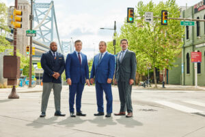 Stampone O'Brien Dilsheimer Holloway partners pose in front of a Philadelphia bridge
