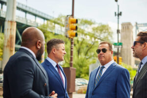 The four partners talk on a street corner in Philly
