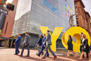 The Stampone O'Brien Dilsheimer Holloway team walk in front of the Yo art installation in Philadelphia