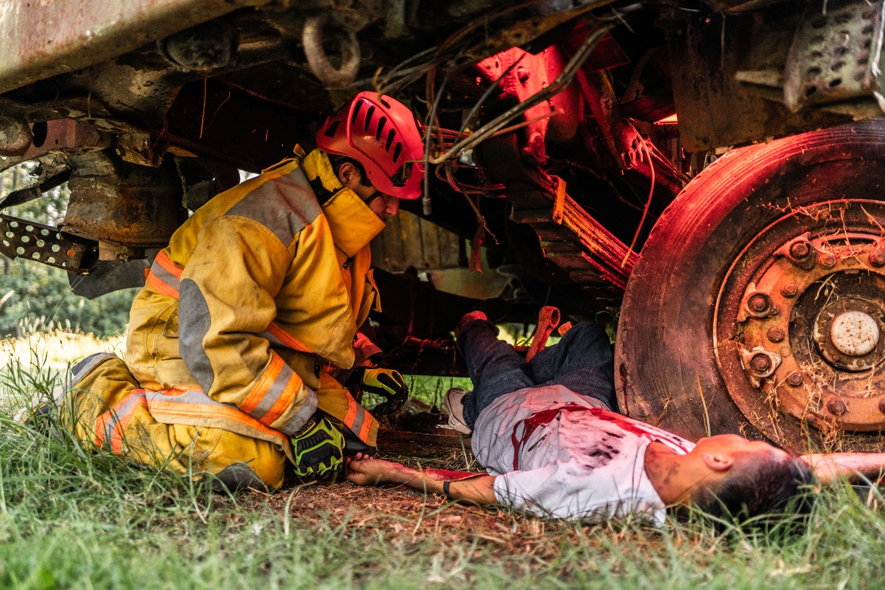 Firefighters helping a car accident victim